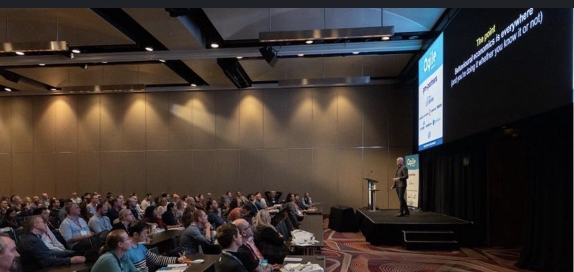 On stage at AgileAus23, Hilton Sydney, presenting to a full ballroom