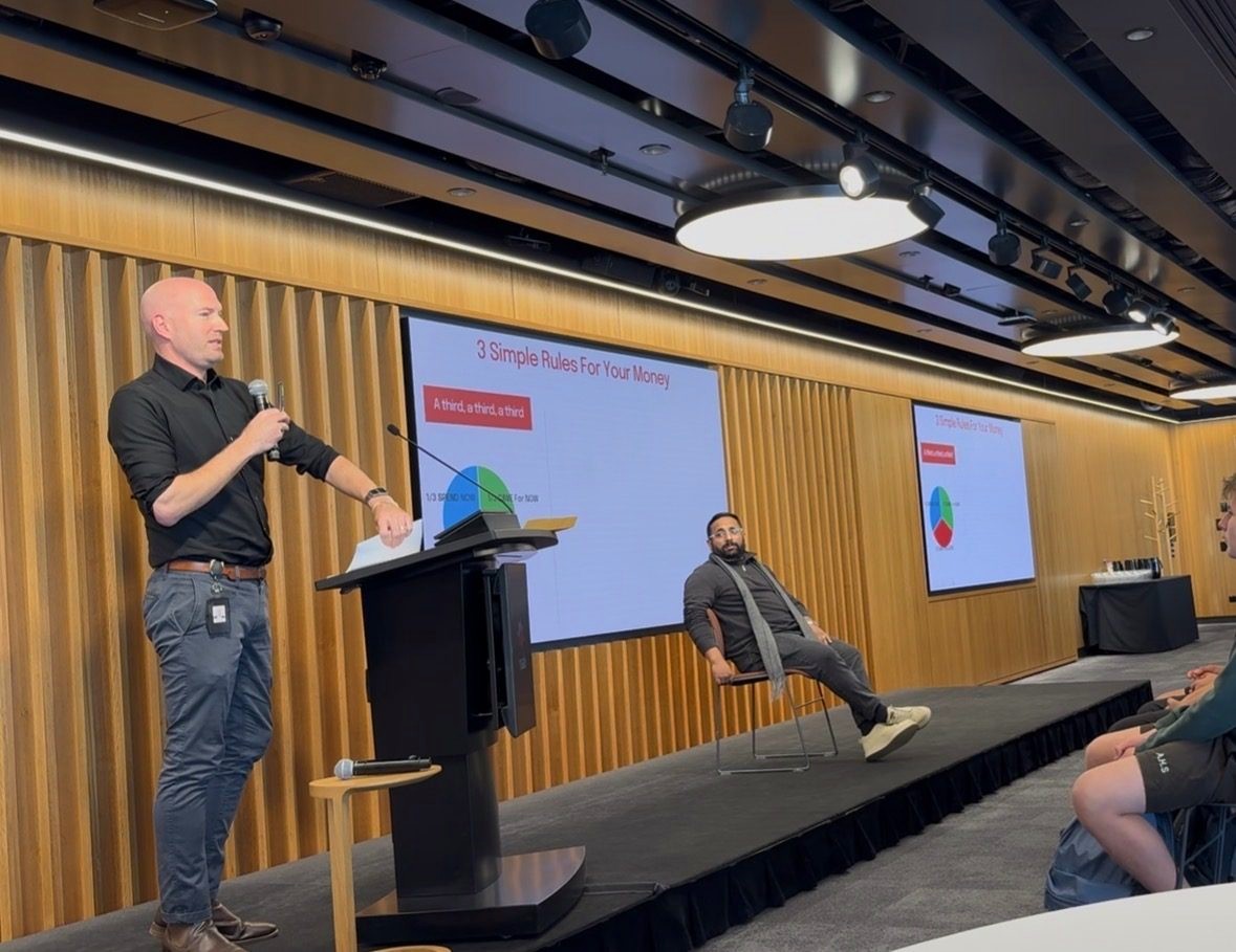 At the podium, presenting the “a third, a third, a third” rule